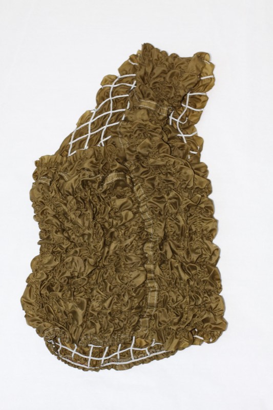The same olive satin bodice with the cord lattice released, collapsed into dense ruching and smocking.