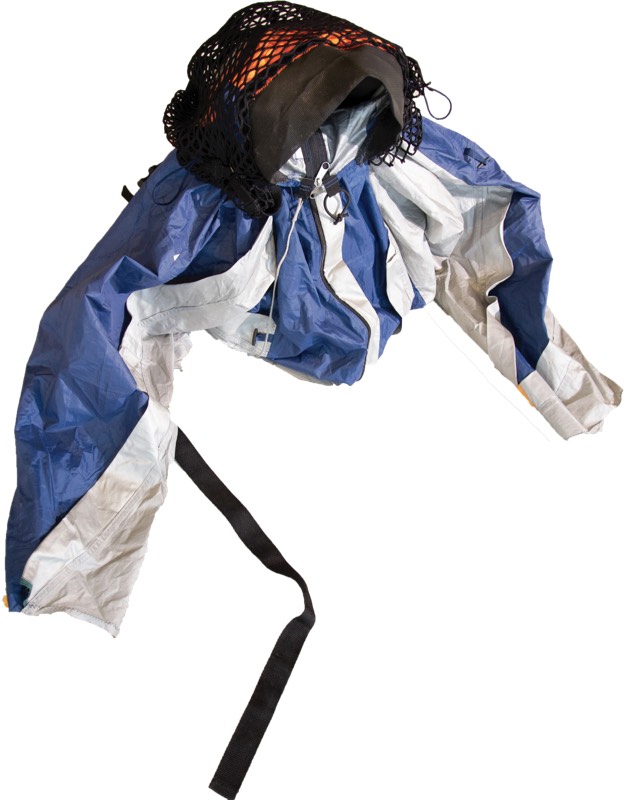 A cropped ripstop jacket panelled in royal blue and off-white with three zips, a knotted black net hood over orange lining, and a trailing webbing strap.